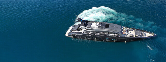 Wall Mural - Aerial drone ultra wide photo of luxury yacht cruising in deep blue sea near Mediterranean Aegean Sea island