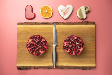 Wall Mural - ripe pomegranate on a pink background. love. Fruit