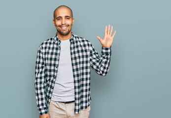 Poster - Hispanic adult man wearing casual clothes showing and pointing up with fingers number five while smiling confident and happy.