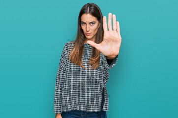 Young beautiful woman wearing casual clothes doing stop sing with palm of the hand. warning expression with negative and serious gesture on the face.