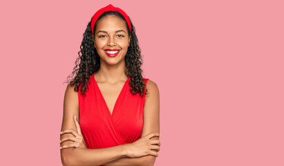 Young african american girl wearing elegant and sexy look happy face smiling with crossed arms looking at the camera. positive person.