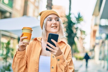 Sticker - Young blonde girl using smartphone and drinking coffee at the city.