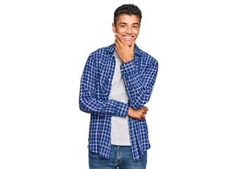 Poster - Young handsome african american man wearing casual clothes looking confident at the camera smiling with crossed arms and hand raised on chin. thinking positive.