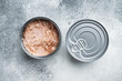 Canned Chunk Light Tuna, in tin can, on gray background, top view flat lay