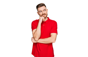 Wall Mural - Young redhead man wearing casual clothes with hand on chin thinking about question, pensive expression. smiling with thoughtful face. doubt concept.