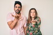 © Krakenimages.com - Beautiful young couple of boyfriend and girlfriend together looking at the camera blowing a kiss with hand on air being lovely and sexy. love expression.