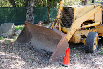 An abandoned earth mover vehicle at a discontinued construction site