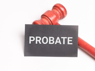 Phrase PROBATE written on black card with gavel isolated on white background. Law concept.