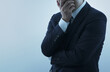© tadamichi - Businessperson feeling anxiety and stress. Suffering and tired man. Gray background and copy space.