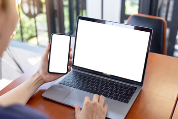 computer screen,cell phone blank mockup.hand woman work using laptop texting mobile.white background for advertising,contact business search information on desk in cafe.marketing,design