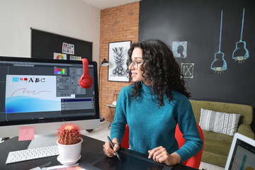 Young female designer working in office