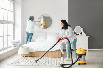 Poster - Mature couple cleaning their bedroom