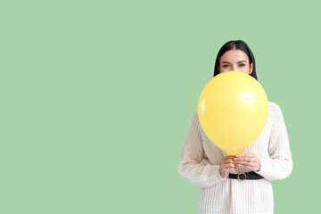 Poster - Beautiful young woman with balloon on color background