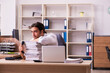 © Elnur - Young male employee unhappy with excessive work in the office