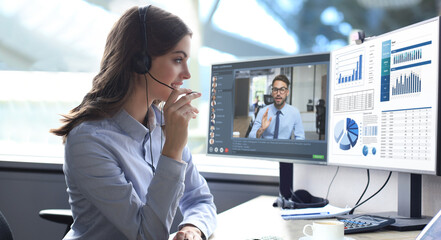 Young call center woman working on computer, doing video conference with collegues on PC. Discussing financial report of their company. Distance work. Coronavirus.