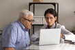 © fizkes - Close up female professional doctor consulting mature patient wearing glasses, using laptop, demonstrating medical checkup result, explaining prescription, treatment, healthcare service concept