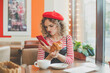 © artmim - Dissatisfied woman using smartphone in european city street cafe. Failed date
