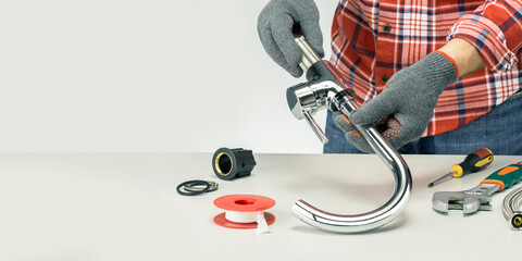 Wall Mural - Plumber Assembling The Kitchen Faucet On Gray Table With Copy Space.