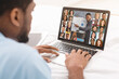 © Prostock-studio - Online Training. Black Man Watching Web Conference With Group Of Business People