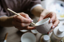 Hand-painting Homemade Ceramic Dishes.