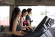 © Blanscape - woman run and talk with friends on treadmills in gym