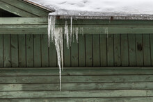 Green Wooden House With Hanging Icicle