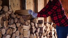 Woman Stacking Logs In A Wood Shed