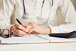 © Maks_Lab - a doctor writes down information with a pen in a diary