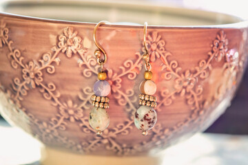 Wall Mural - Mineral stone earrings hanging on a bowl