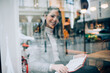© GalakticDreamer - Smiling woman in cafe reading book