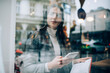 © GalakticDreamer - Serious woman with mobile phone in cafeteria