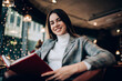 © GalakticDreamer - Positive woman with book in cafeteria