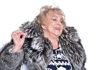 senior woman in fur coat posing