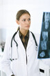 © Iryna - Woman-doctor examining x-ray picture in hospital. Surgeon or orthopedist at work in clinic. Medicine and healthcare concept
