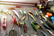 Fishing tackle - fishing spinning rod, hooks and lures on gray background. Active hobby recreation concept.