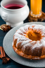 Wall Mural - Bundt cake with sugar powder with copy space. Homemade ring cake with icing sugar on wooden table, closeup, rustic style.