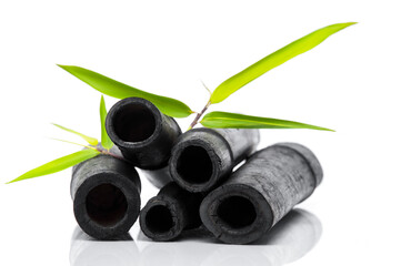 Bamboo charcoal water filter sticks and green leaf. Natural bamboo charcoal is a powerful purifier which refreshes tap water. Deodorization, air filtration, and decor concept.