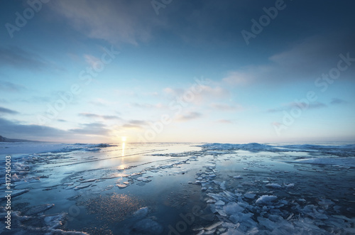 Canvas Print Panoramic view of the snow-covered shore of the frozen Baltic sea at sunset