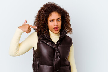 Wall Mural - Young african american woman isolated on white background person pointing by hand to a shirt copy space, proud and confident