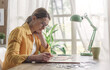 © StockPhotoPro - Young woman solving a puzzle at home