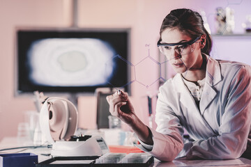 Poster - Portrait of a confident female health care expert in life science laboratory writing structural chemical formula on a glass board. Healthcare and modern life science concept. Blue toned image.