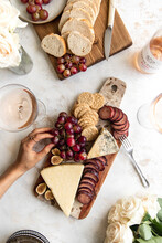 Fall Cheeseboard With Hand In Frame And Rose.
