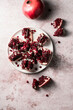 © The Picture Pantry - Pomegranate sliced open on a white plate.