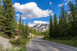 Mountain road in the forest in summer time. Lake Minnewanka scenic drive Loop. Banff National Park, Canadian Rockies, Alberta, Canada.