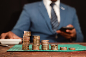 A business man wearing a modern suit and showing a graph of money Business growth World market financial analysis concept