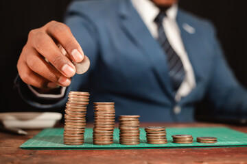 A business man wearing a modern suit and showing a graph of money Business growth World market financial analysis concept