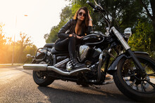 Sexy Young Woman In Black Wearing Sunglasses Posing On Vintage Bike At Sunset 