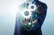 © tadamichi - Automation of business processes by network technology. Businessperson, gears icon and network structure.