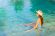 © siraphol - Portrait beautiful young asian woman relax smile enjoy leisure around swimming pool