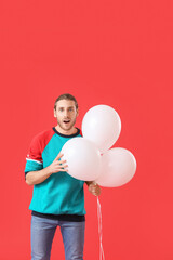 Sticker - Surprised young man with balloons on color background